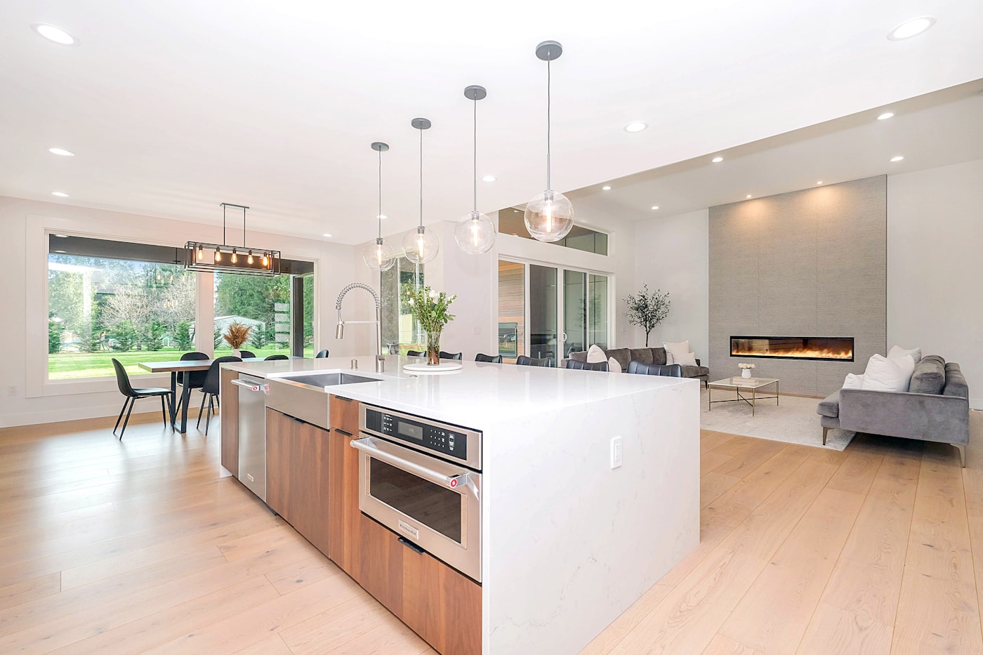 Modern open-concept kitchen with waterfall island and pendant lighting